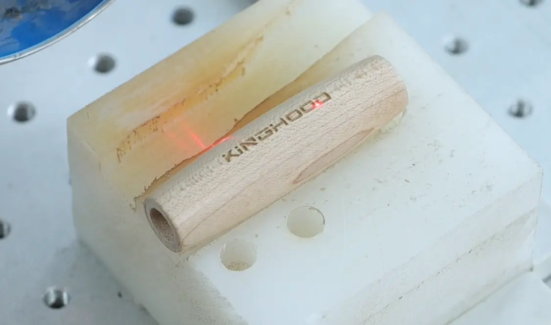 Engraved Kinghood branding on a black razor handle