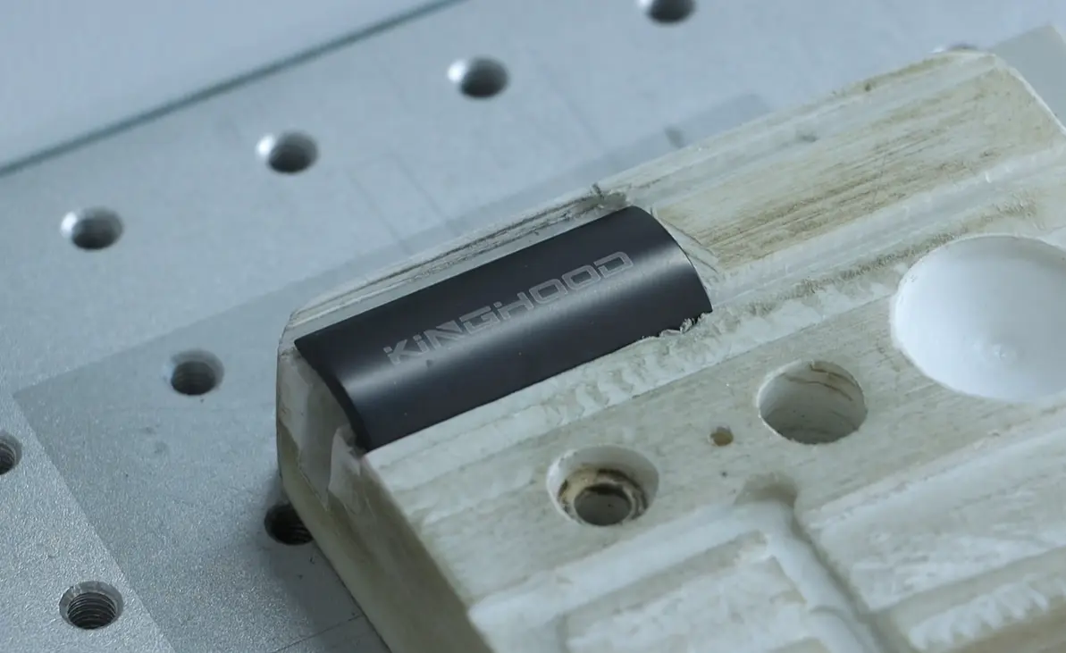 Laser marking a Kinghood logo on a wooden razor handle