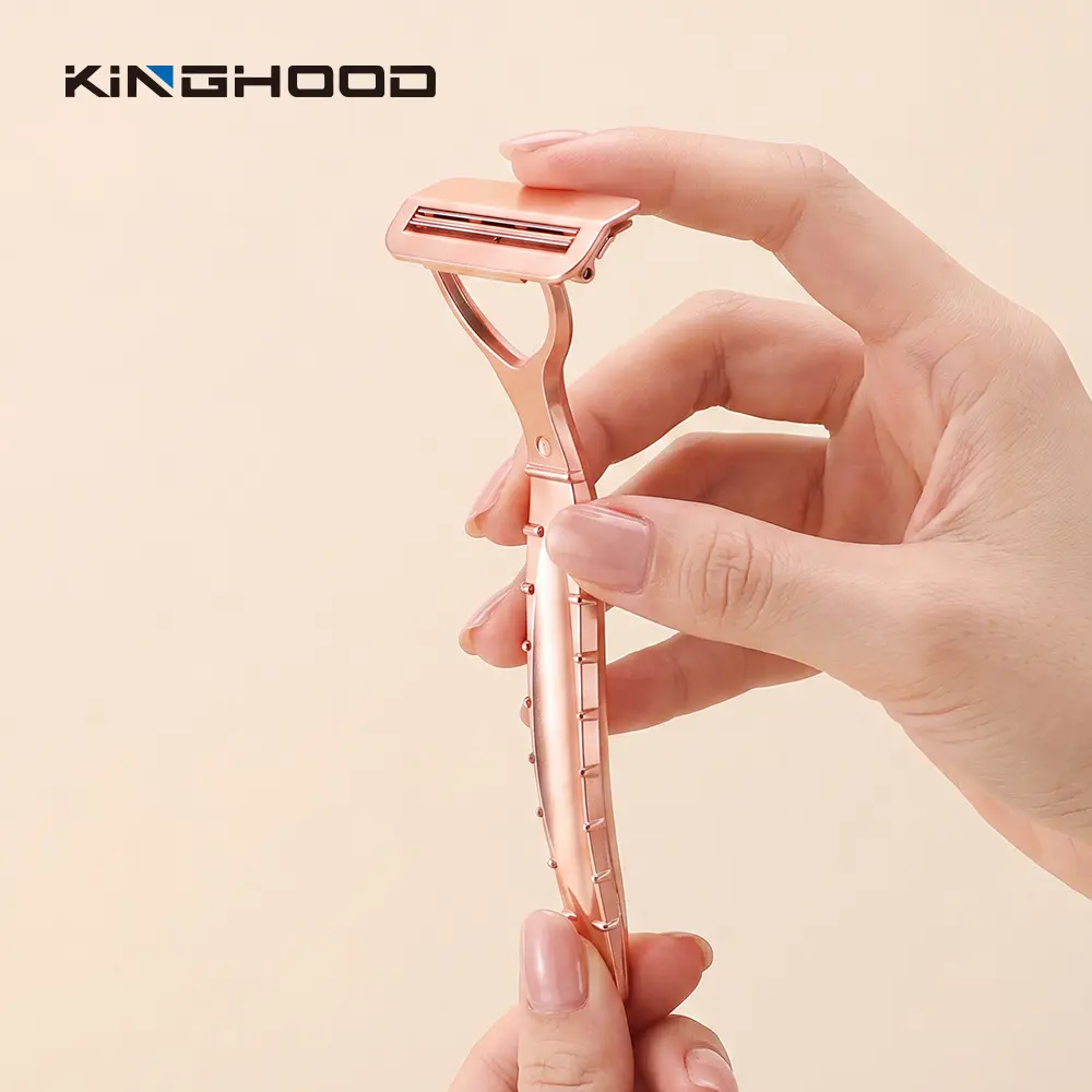 Hands opening the quick-open head of a rose gold pivoting razor