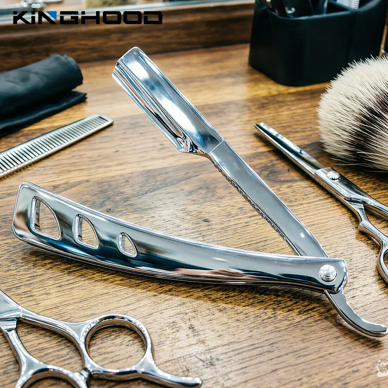 Polished straight razor displayed with professional barber tools